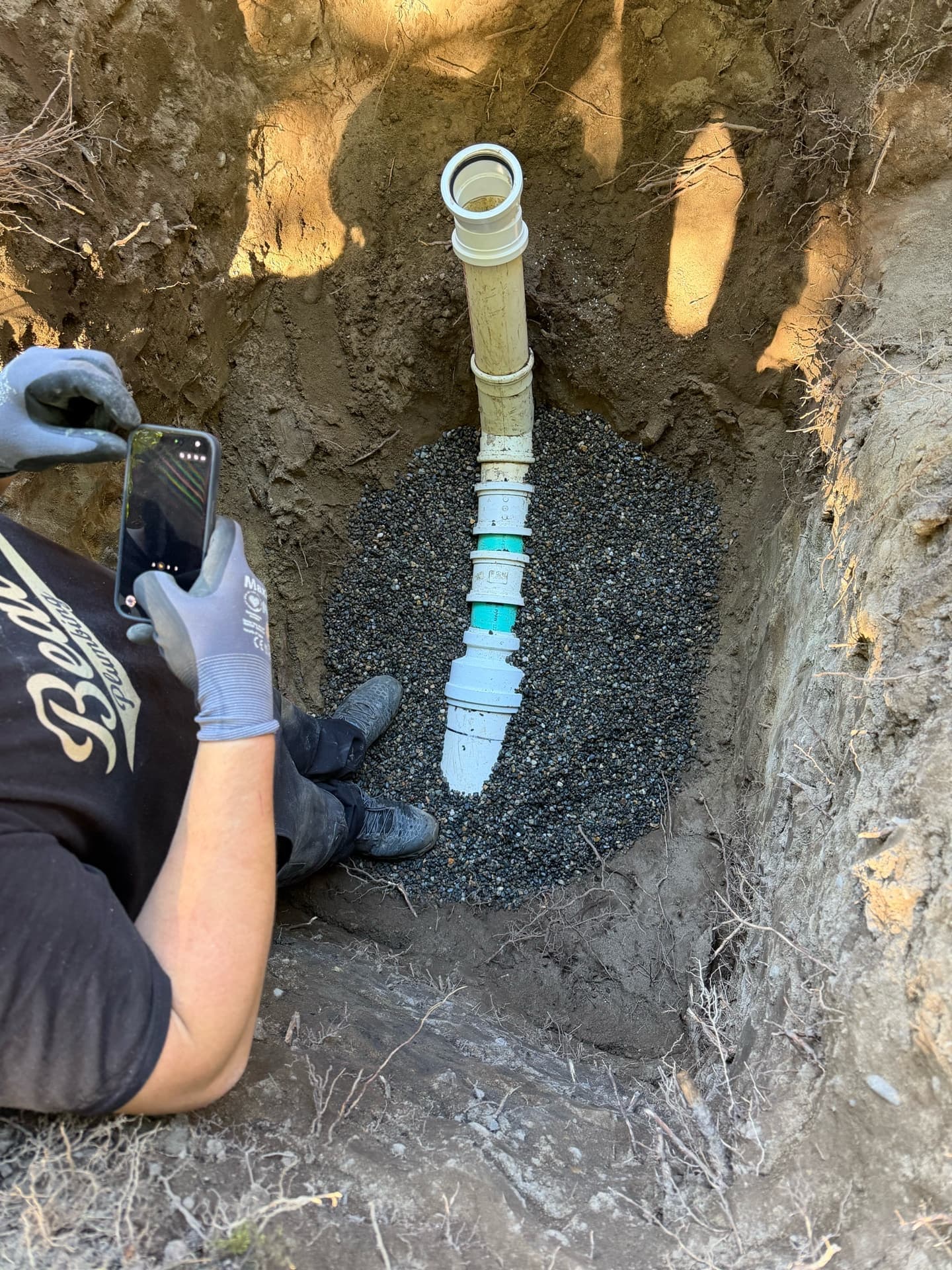 A buried water line exposed in a hand-dug trench during a Beaver's Plumbing repair